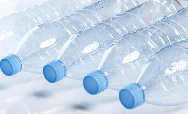 Larger water bottles with stickers. Bottles of drinking water requiring stickers and labels.